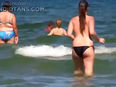 Huge boobs topless on the beach